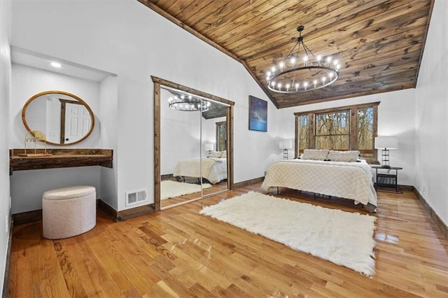 unfurnished bedroom with a notable chandelier, light hardwood / wood-style flooring, high vaulted ceiling, a closet, and wooden ceiling