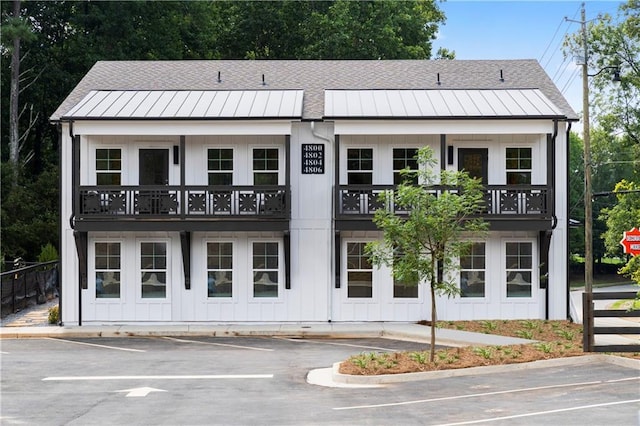 view of property featuring uncovered parking and fence