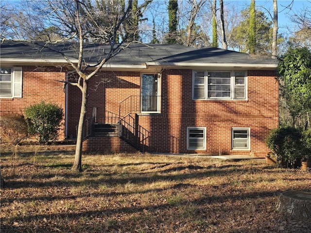 view of property exterior with a lawn and brick siding