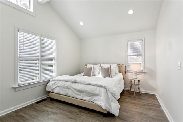 bedroom with lofted ceiling and hardwood / wood-style floors