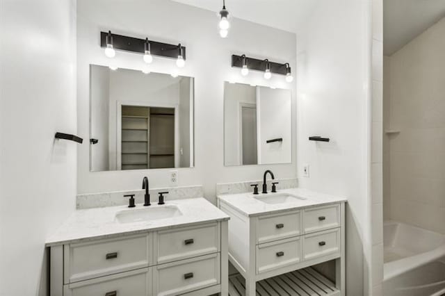 bathroom with vanity and  shower combination