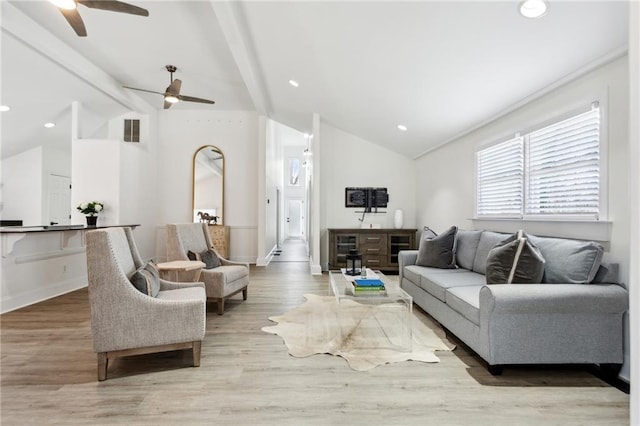 living room featuring vaulted ceiling with beams, light hardwood / wood-style flooring, and ceiling fan