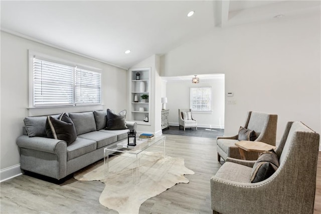 living room with vaulted ceiling with beams and wood-type flooring