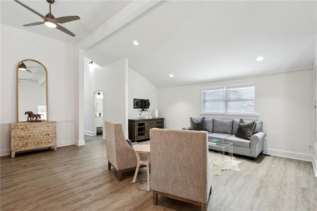 living room with vaulted ceiling, ceiling fan, and light hardwood / wood-style floors