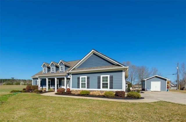 view of front facade featuring a front yard, a porch, an outbuilding, and stone siding