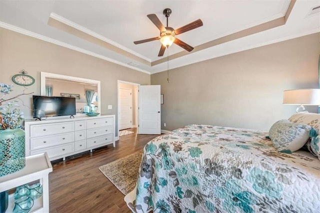 bedroom featuring ceiling fan, a raised ceiling, dark wood finished floors, and crown molding