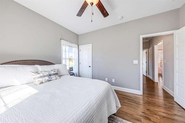 bedroom featuring a ceiling fan, baseboards, and wood finished floors