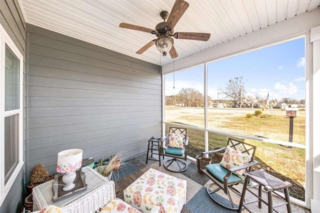 sunroom with ceiling fan and wooden ceiling