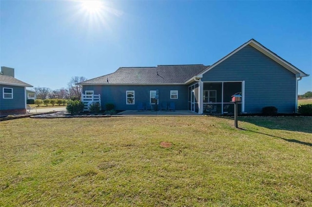 back of property with a lawn and a sunroom