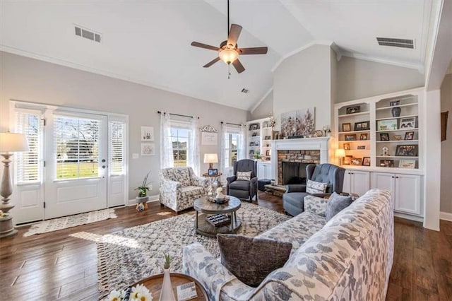 living room with ceiling fan, visible vents, a stone fireplace, and dark wood-style floors