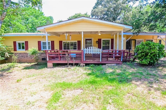 rear view of house with a wooden deck and ceiling fan