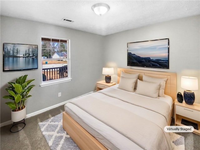 carpeted bedroom featuring visible vents and baseboards