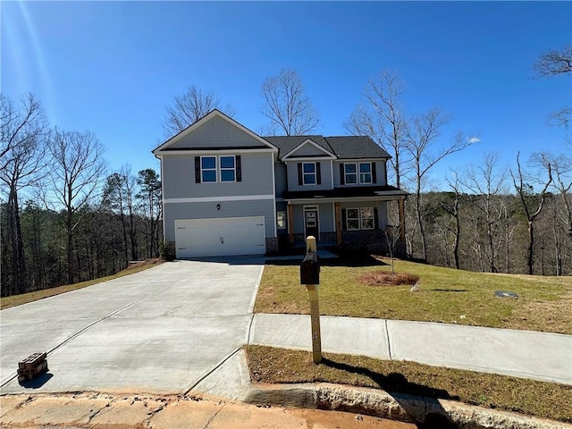 view of front facade featuring an attached garage, concrete driveway, and a front yard