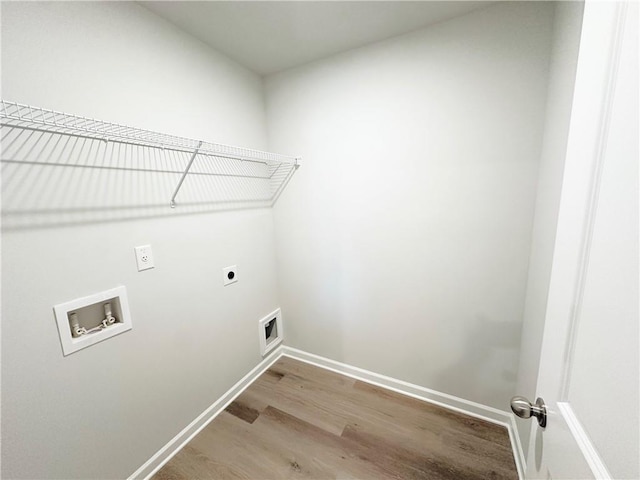 laundry room with electric dryer hookup, light wood-type flooring, washer hookup, baseboards, and laundry area