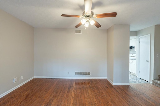 spare room featuring hardwood / wood-style floors and ceiling fan