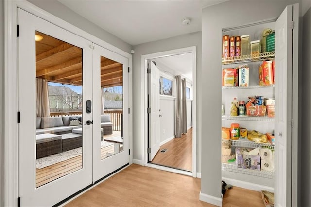 doorway with light hardwood / wood-style flooring and french doors