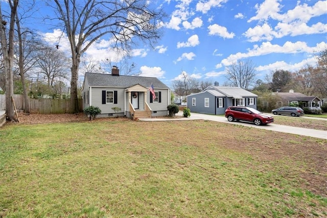 single story home featuring a front lawn