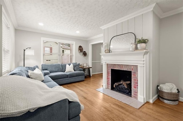 living room featuring wood-type flooring, a brick fireplace, and ornamental molding