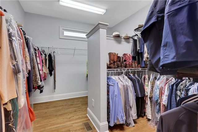 walk in closet with visible vents and wood finished floors