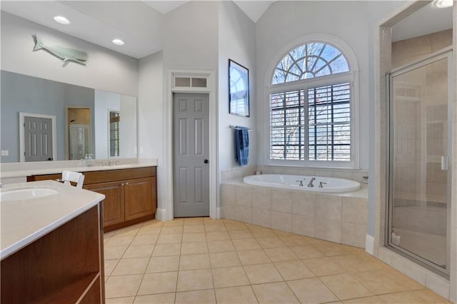 bathroom with tile patterned flooring, plenty of natural light, a stall shower, and a sink