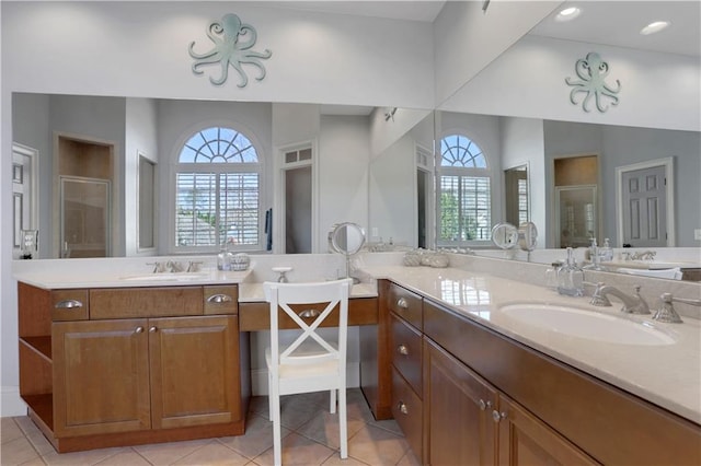 bathroom featuring tile patterned flooring, a stall shower, and vanity