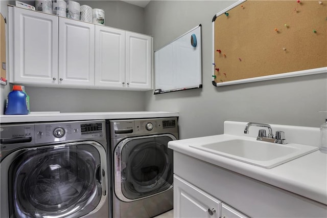 laundry room featuring cabinet space, independent washer and dryer, and a sink