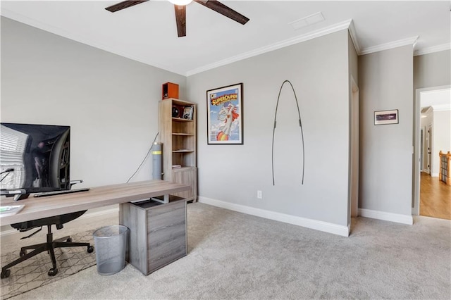 office space featuring baseboards, carpet floors, ceiling fan, and crown molding