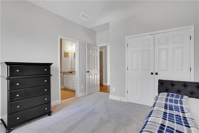 bedroom with visible vents, baseboards, carpet, lofted ceiling, and a closet