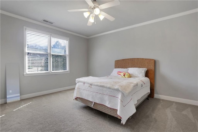 carpeted bedroom featuring visible vents, a ceiling fan, baseboards, and ornamental molding