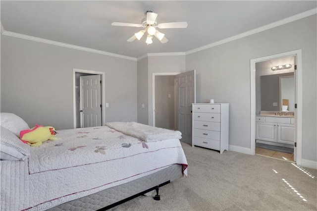 bedroom with baseboards, a sink, ornamental molding, ensuite bathroom, and light colored carpet