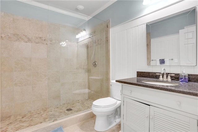 bathroom with toilet, ornamental molding, tile patterned flooring, tiled shower, and vanity