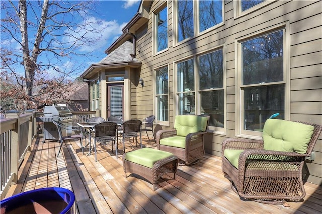 deck featuring grilling area and outdoor dining space