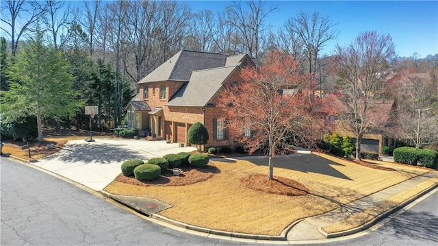 traditional home featuring brick siding and driveway