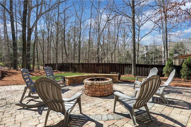 view of patio featuring a fire pit and fence