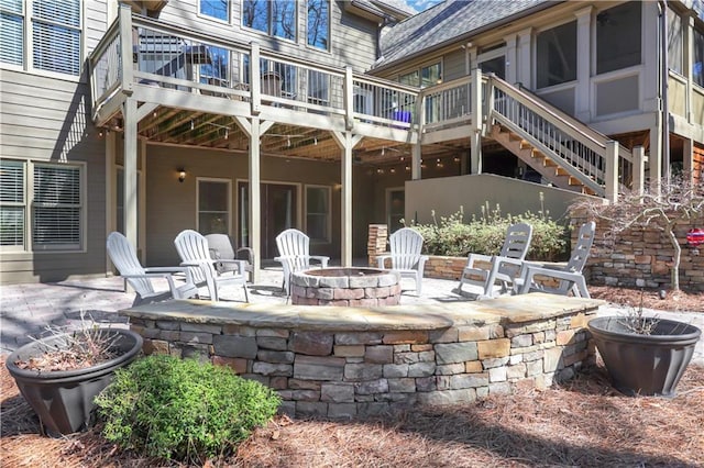 view of patio with a wooden deck, stairway, and an outdoor fire pit