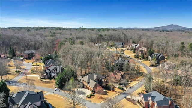 bird's eye view with a wooded view