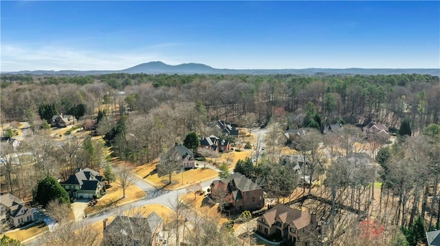 birds eye view of property with a view of trees and a mountain view