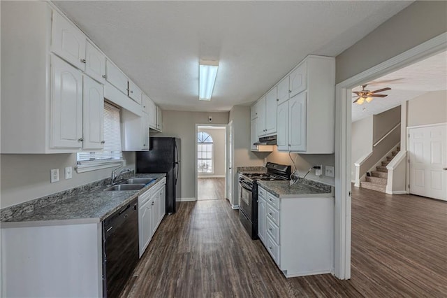 kitchen featuring stone countertops, dark hardwood / wood-style flooring, sink, white cabinets, and black appliances