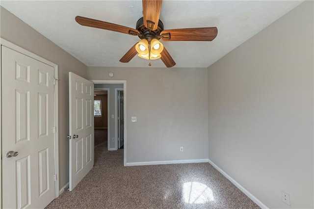 unfurnished bedroom featuring ceiling fan and a textured ceiling