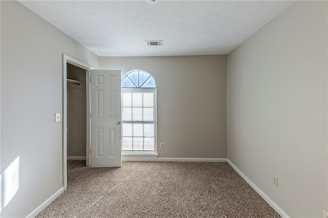 unfurnished bedroom with a closet and carpet flooring