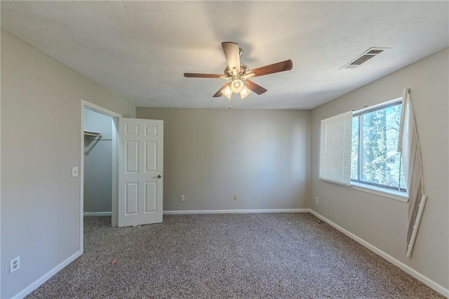 unfurnished bedroom featuring a closet, ceiling fan, and carpet flooring