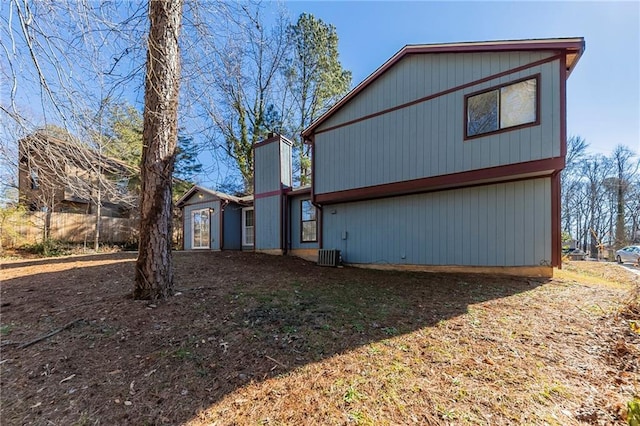 rear view of property featuring central AC unit