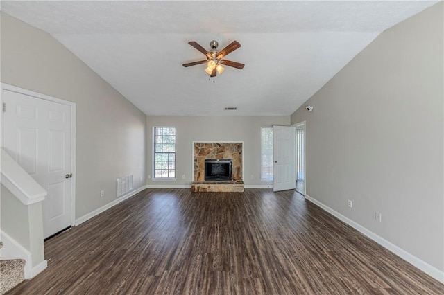 unfurnished living room with ceiling fan, dark wood-type flooring, lofted ceiling, and a fireplace