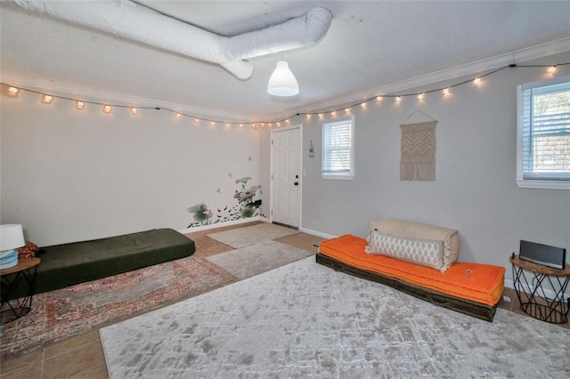 living area featuring tile patterned flooring and ornamental molding