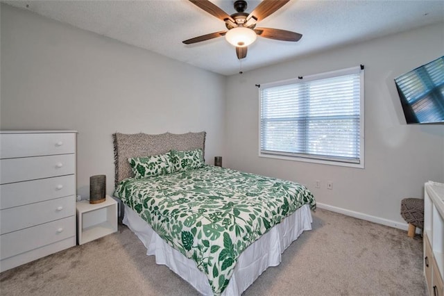 bedroom with ceiling fan and light carpet