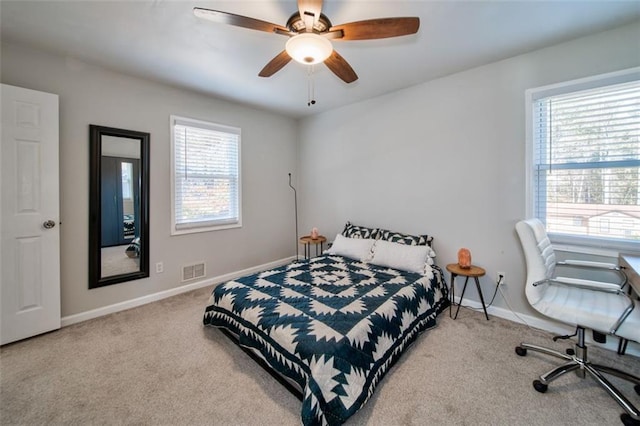 bedroom featuring multiple windows, ceiling fan, and carpet