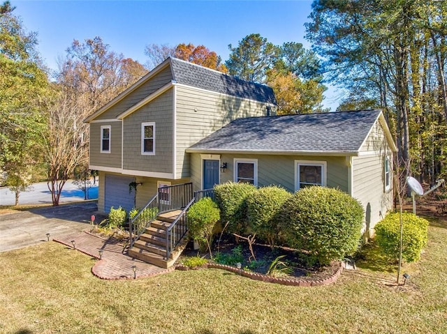 split level home featuring a garage and a front yard