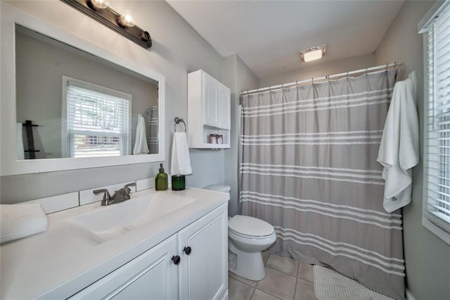 bathroom featuring vanity, tile patterned floors, and toilet