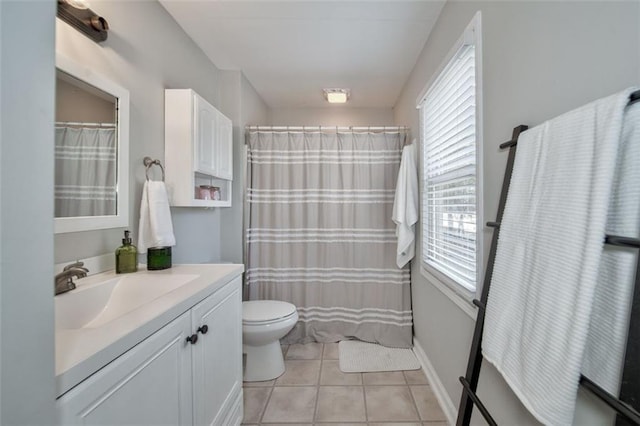 bathroom featuring vanity, tile patterned floors, toilet, and walk in shower