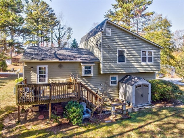 back of house with a wooden deck, a yard, and a storage shed